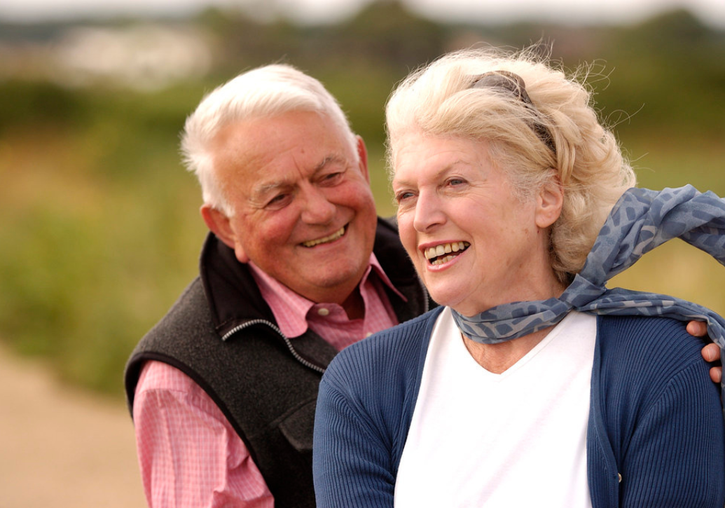 Couple smiling with strong dental implants